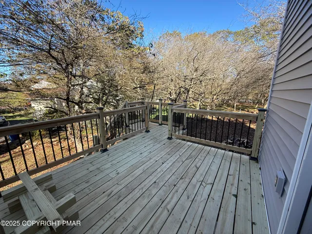 a balcony with wooden floor and city view