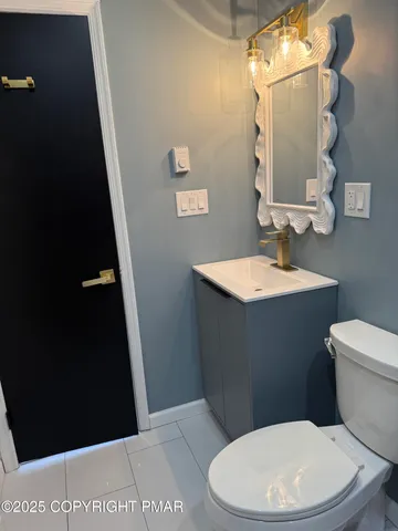 a white toilet sitting next to a bathroom sink