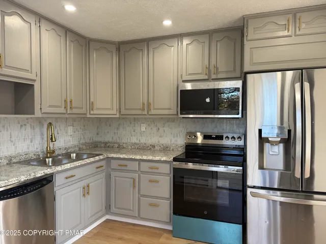 a kitchen with a sink stove and refrigerator