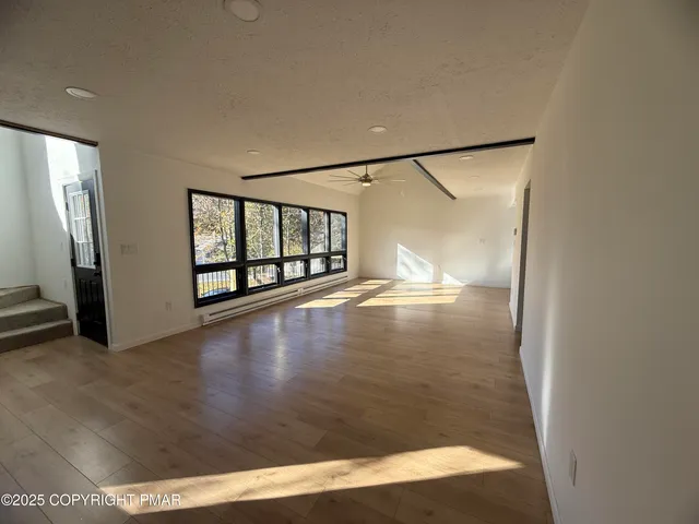 a view of a livingroom with a fireplace and window