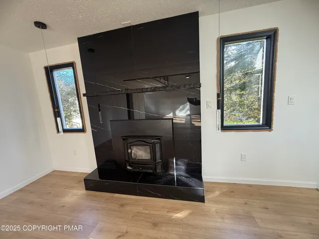 a view of a hallway to a house with wooden floor