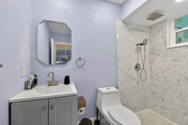 a bathroom with a toilet and a shower