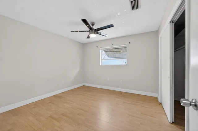 a view of a room with wooden floor