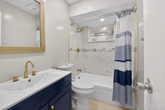 a bathroom with a toilet a sink and bathtub
