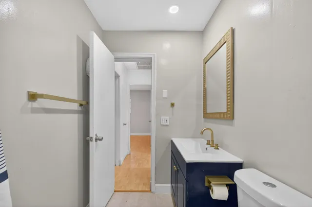 a view of a big room with wooden floor closet and windows