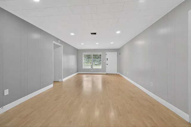 an empty room with windows and entrance