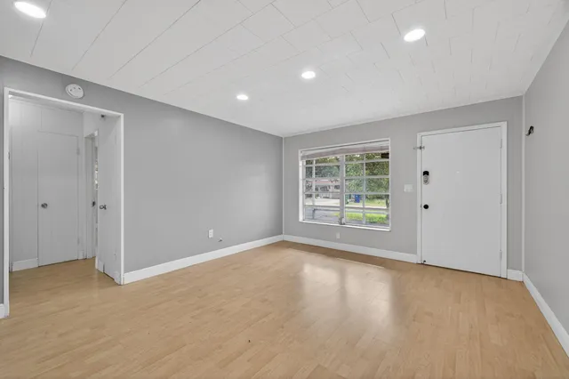 a large kitchen with stainless steel appliances granite countertop a stove a sink dishwasher a microwave oven and a refrigerator