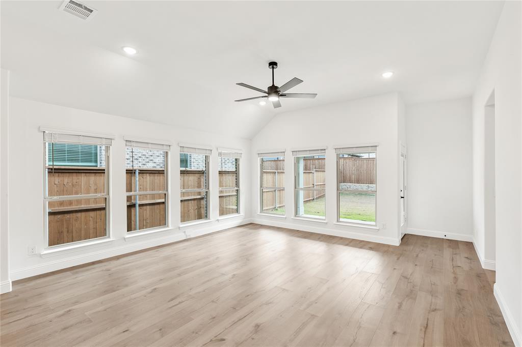 14509 Lovelace Street Pilot Point, TX 76258 - Photo 14 of 35 a view of an empty room with a window and wooden floor