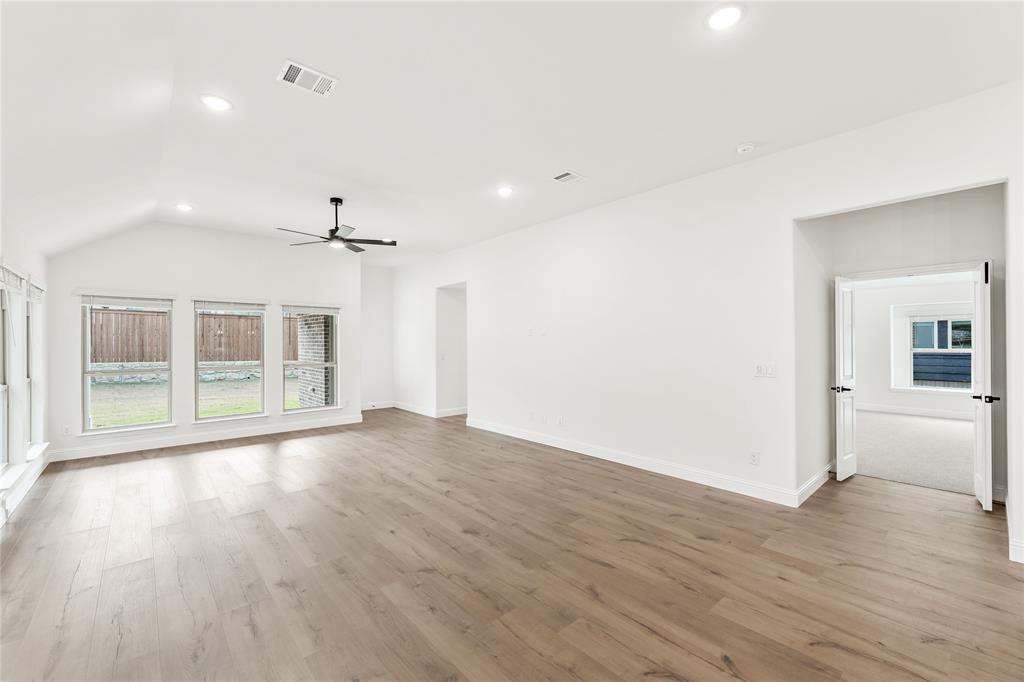 14509 Lovelace Street Pilot Point, TX 76258 - Photo 17 of 35 wooden floor in an empty room with a window