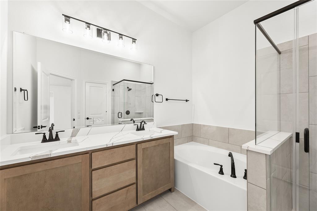 14509 Lovelace Street Pilot Point, TX 76258 - Photo 21 of 35 a bathroom with a tub a sink and mirror