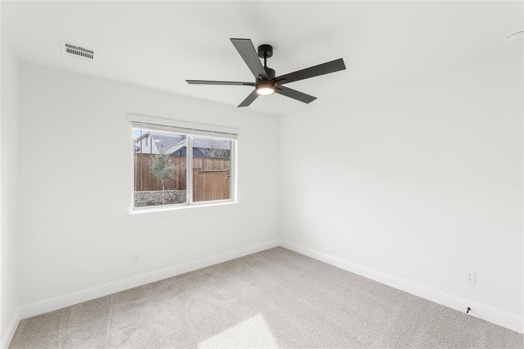 14509 Lovelace Street Pilot Point, TX 76258 - Photo 24 of 35 an empty room with a window and a fan