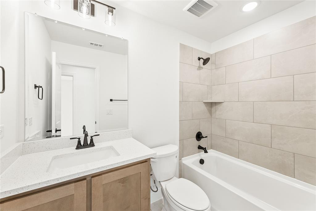 14509 Lovelace Street Pilot Point, TX 76258 - Photo 25 of 35 a bathroom with a sink a toilet and shower