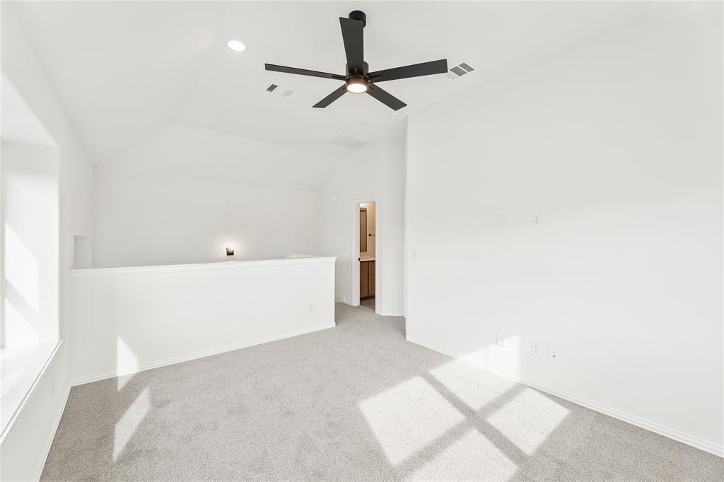 14509 Lovelace Street Pilot Point, TX 76258 - Photo 28 of 35 a view of a room with a ceiling fan and wooden floor