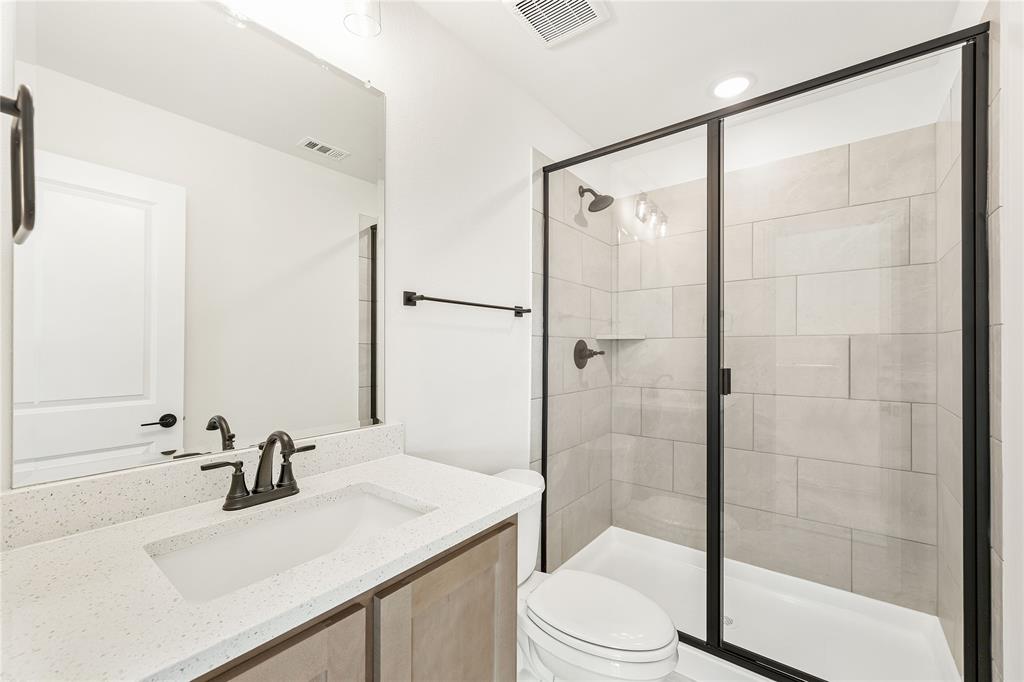 14509 Lovelace Street Pilot Point, TX 76258 - Photo 30 of 35 a bathroom with a sink toilet and shower