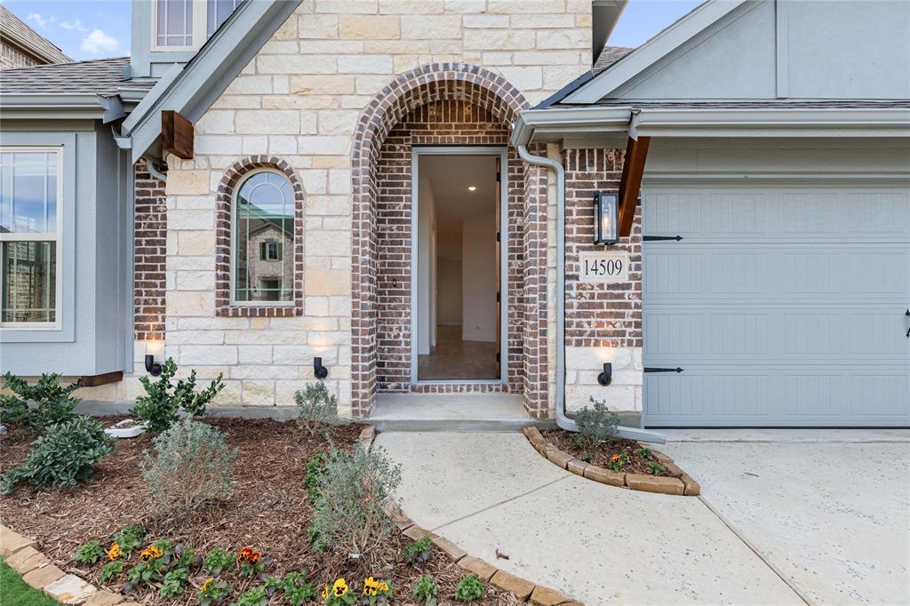 14509 Lovelace Street Pilot Point, TX 76258 - Photo 4 of 35 a front view of a house with garden