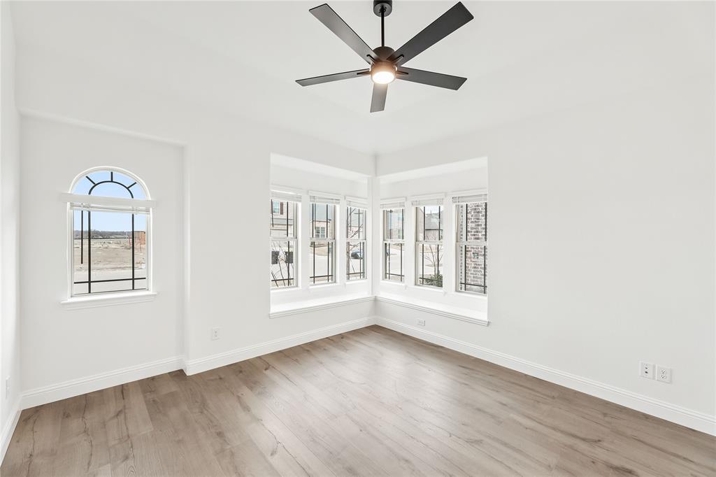 14509 Lovelace Street Pilot Point, TX 76258 - Photo 6 of 35 a view of an empty room with a window and wooden floor