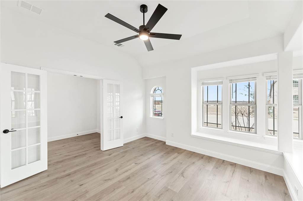 14509 Lovelace Street Pilot Point, TX 76258 - Photo 7 of 35 an empty room with wooden floor and windows