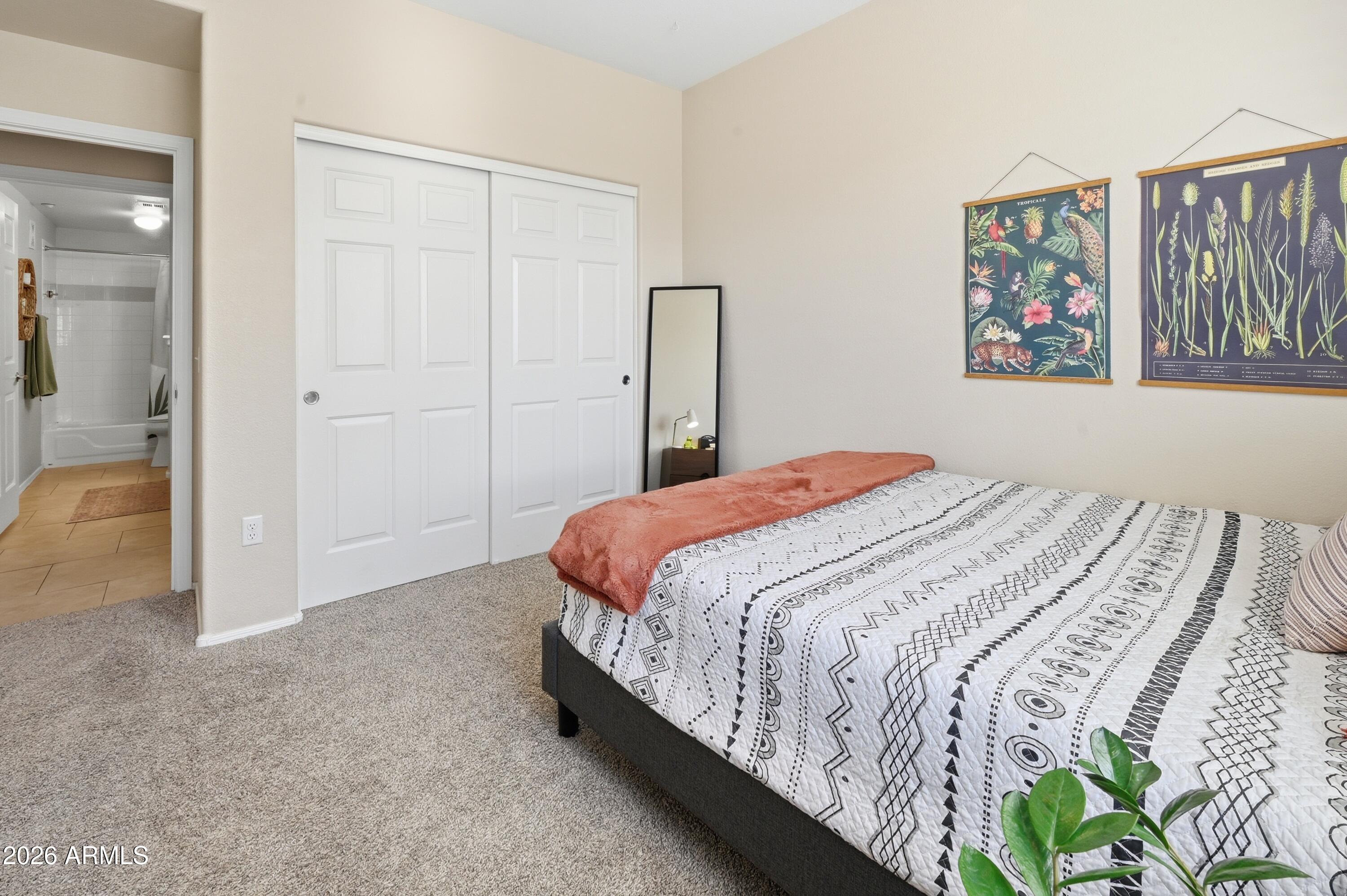 5303 North 7th Street, Unit 220 Phoenix, AZ 85014 - Photo 22 of 33 a bedroom with a bed and a painting on the wall