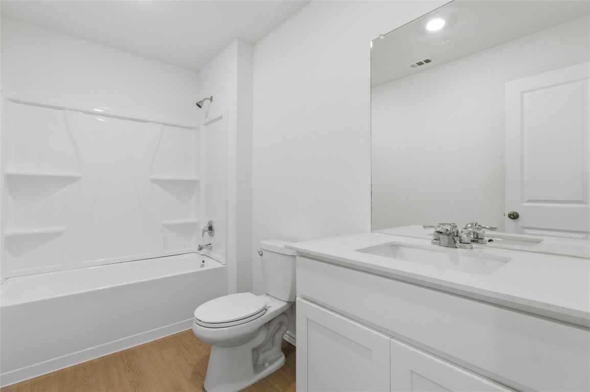 596 Sormonne Loop Kyle, TX 78640 - Photo 14 of 25 a bathroom with a sink a toilet and shower