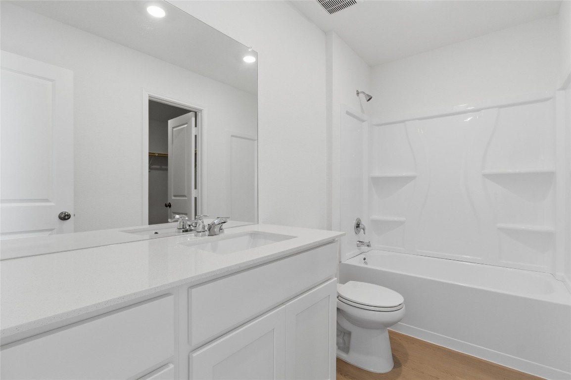 596 Sormonne Loop Kyle, TX 78640 - Photo 15 of 25 a bathroom with a sink a toilet and shower