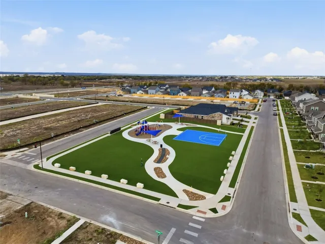 an aerial view of residential houses with outdoor space