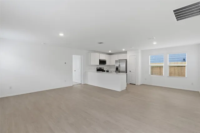 a view of a kitchen with a sink and cabinets