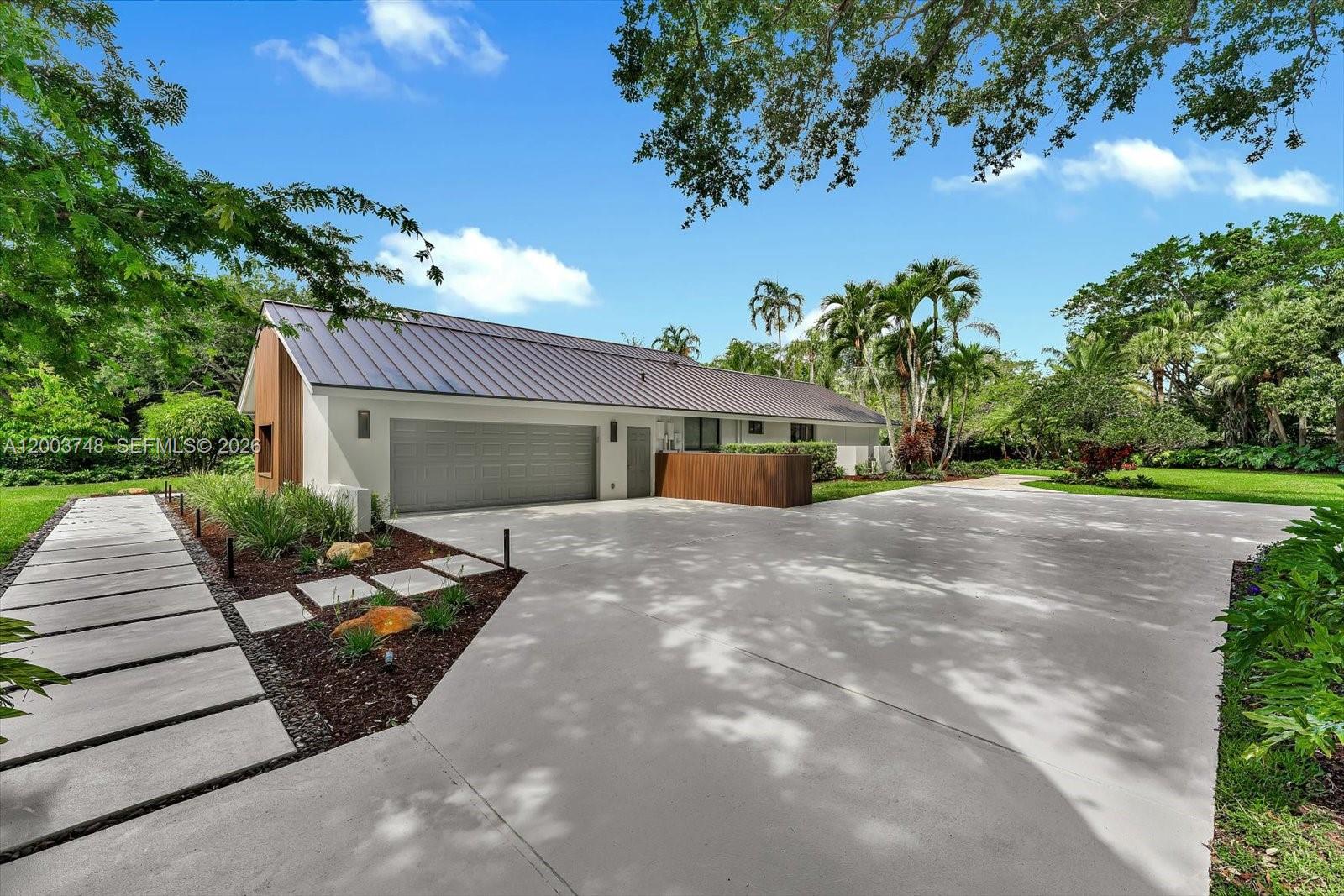 2675 Hackney Road Weston, FL 33331 - Photo 57 of 61 a front view of a house with garden