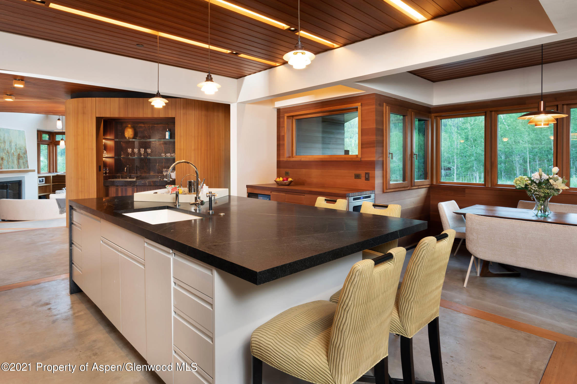 255 Conundrum Creek Road Aspen, CO 81611 - Photo 12 of 70 a kitchen with a table chairs sink and wooden floor