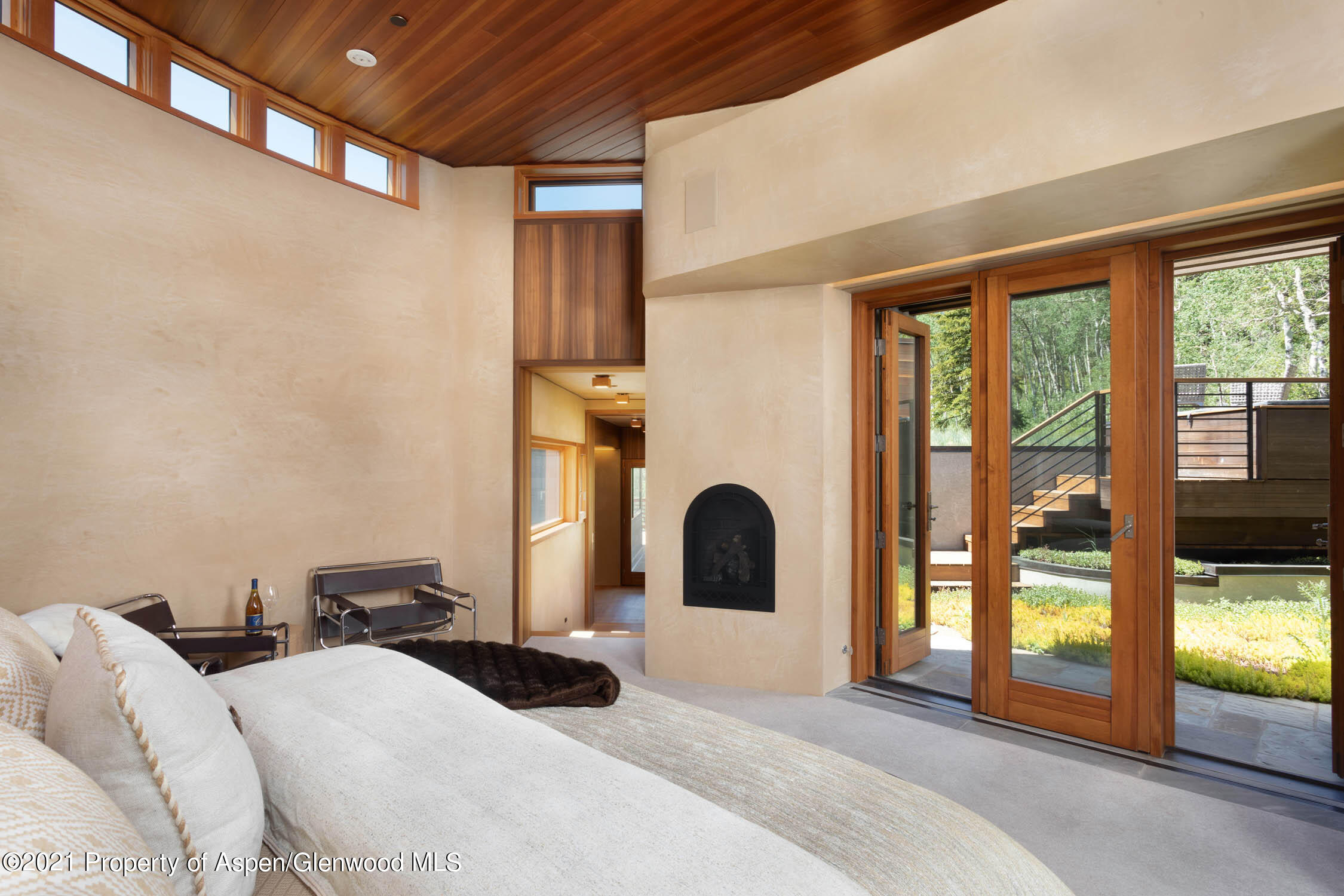 255 Conundrum Creek Road Aspen, CO 81611 - Photo 22 of 70 a bedroom with a large bed and large windows