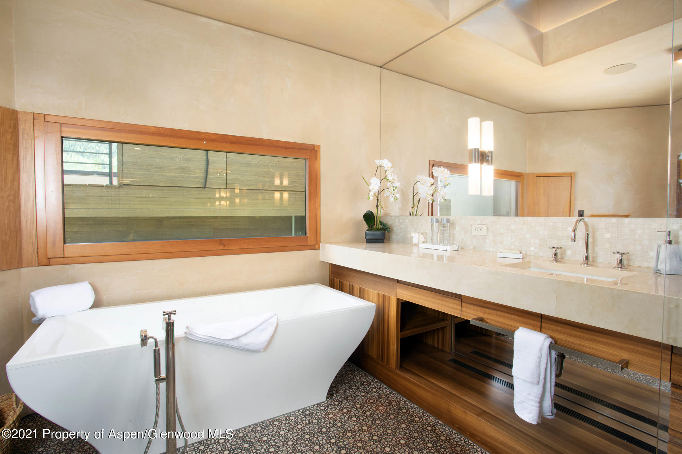 255 Conundrum Creek Road Aspen, CO 81611 - Photo 27 of 70 a bathroom with a granite countertop sink and a large mirror