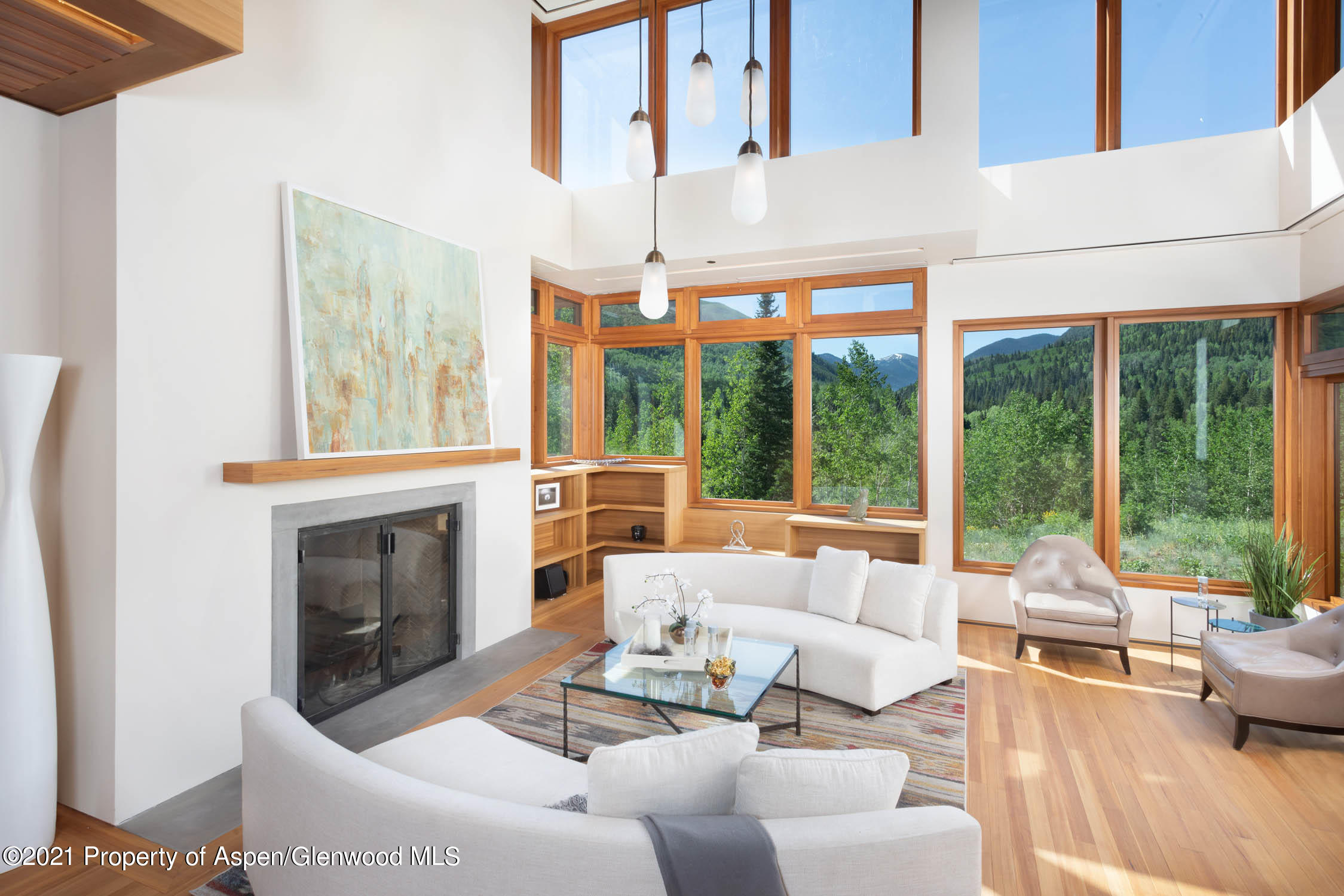 255 Conundrum Creek Road Aspen, CO 81611 - Photo 5 of 70 a living room with furniture a fireplace and floor to ceiling windows