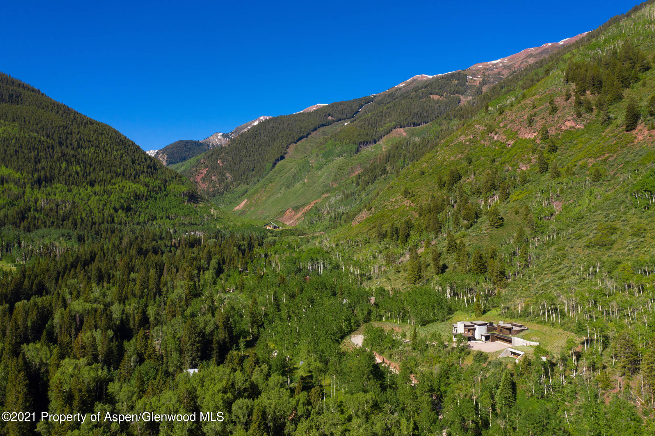 255 Conundrum Creek Road Aspen, CO 81611 - Photo 55 of 70 a view of a large building with a mountain in the background