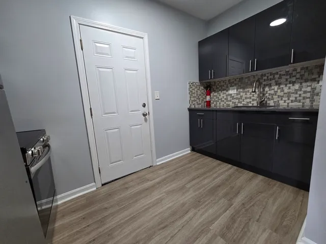 a room with wooden floor and cabinets