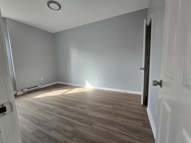 a view of wooden floor and windows in a room