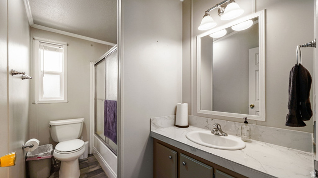 490 South Main Street Kamas, UT 84036 - Photo 12 of 25 Bathroom featuring a vanity with a white countertop and integrated sink, a framed mirror, and a three-light vanity fixture