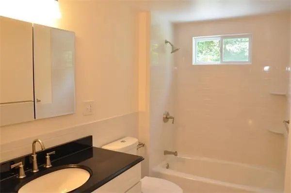 a bathroom with a toilet a sink and bathtub