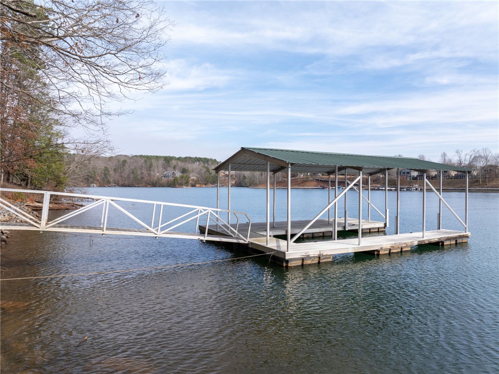 537 Peninsula Road West Union, SC 29696 - Photo 12 of 15 This private dock with covered slips offers direct access to tranquil waters, perfect for leisure and recreation.