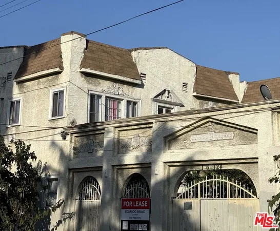 a view of a house with brick wall and windows