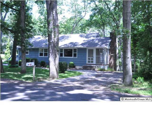 1140 Ivy Road Manasquan, NJ 08736 - Photo 1 of 3 a front view of a house with yard porch and outdoor seating