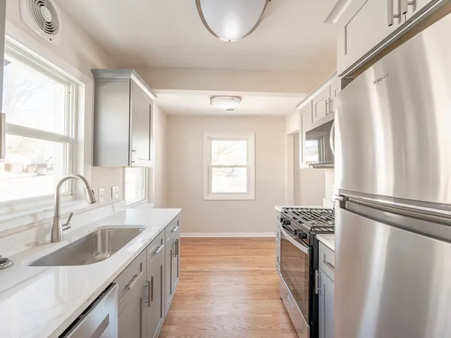 a kitchen with stainless steel appliances a sink and a window