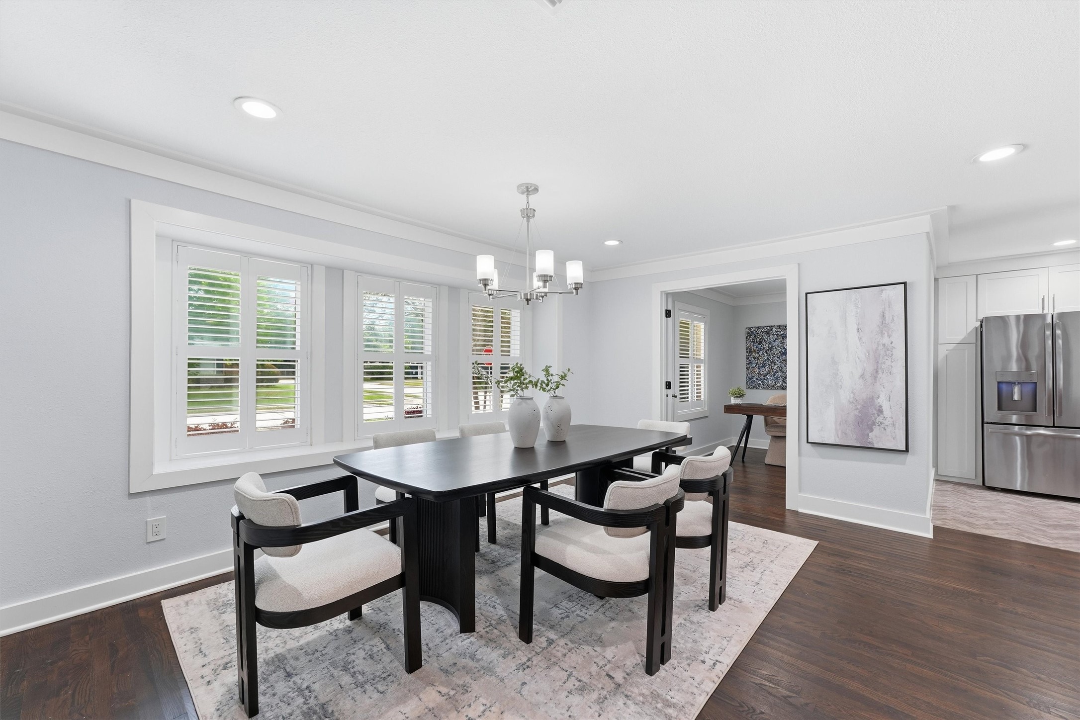 4701 Hummingbird Street Houston, TX 77035 - Photo 6 of 28 Imagine peaceful dinners in the dining area. With a view of the front yard, plantation shutters, and a chrome light fixture, the tone is relaxed yet elegant. Through the door in the background is the study.