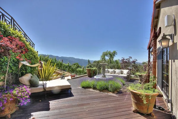a view of a patio with couches and potted plants