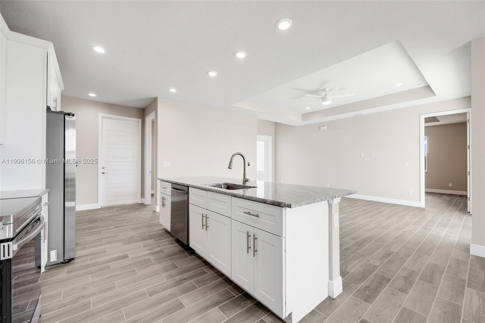 626 Royce Road LaBelle, FL 33935 - Photo 13 of 40 a large kitchen with a lot of counter space and wooden floor