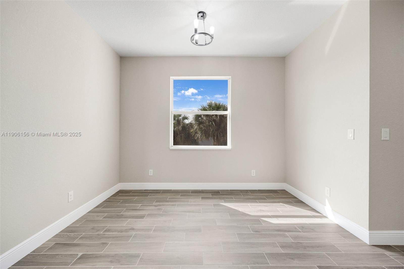 626 Royce Road LaBelle, FL 33935 - Photo 14 of 40 a view of an empty room with wooden floor and window