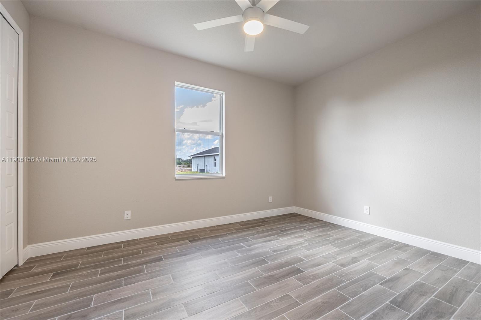 626 Royce Road LaBelle, FL 33935 - Photo 17 of 40 an empty room with wooden floor and windows