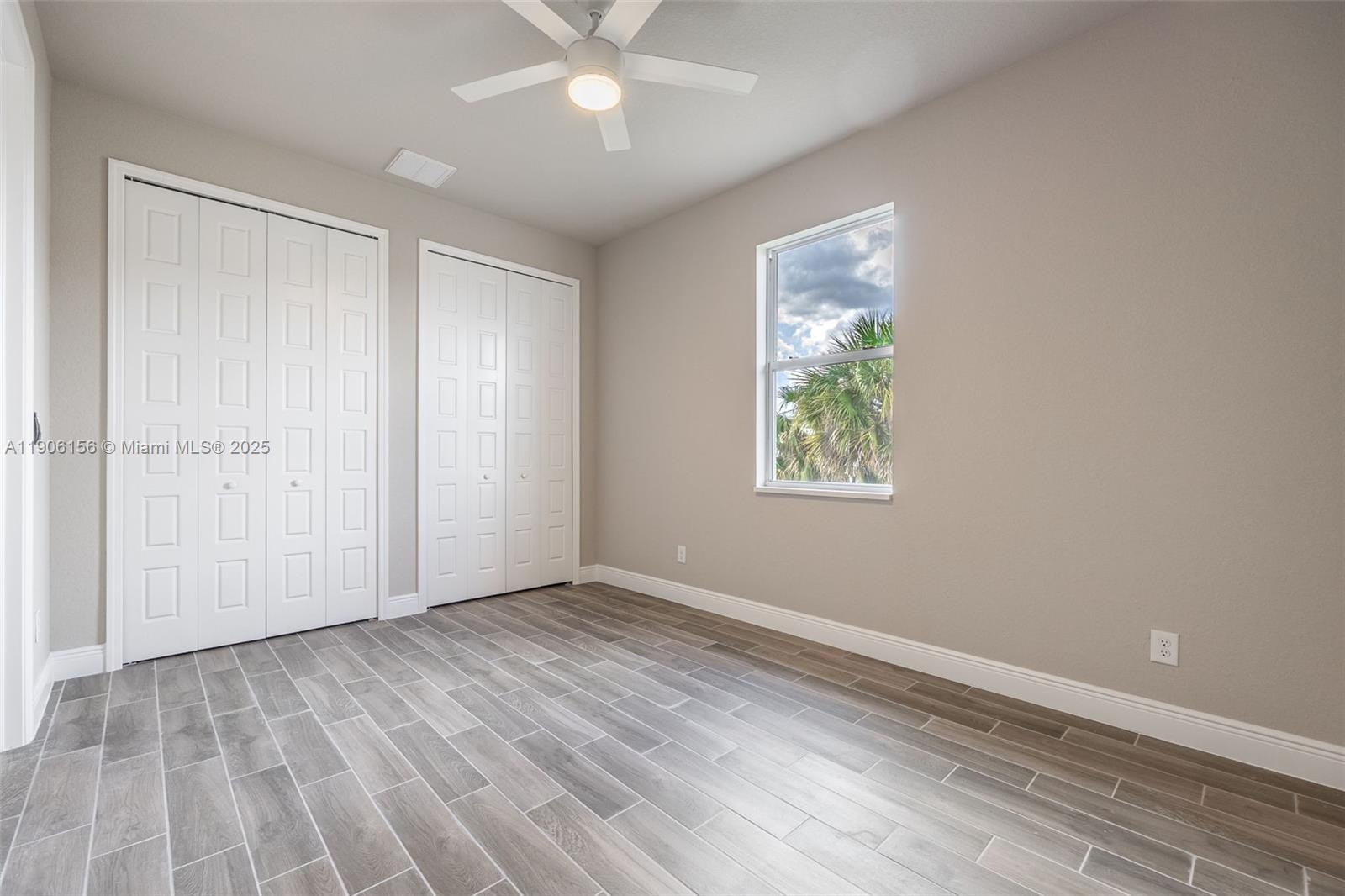626 Royce Road LaBelle, FL 33935 - Photo 19 of 40 a view of an empty room with wooden floor and a window