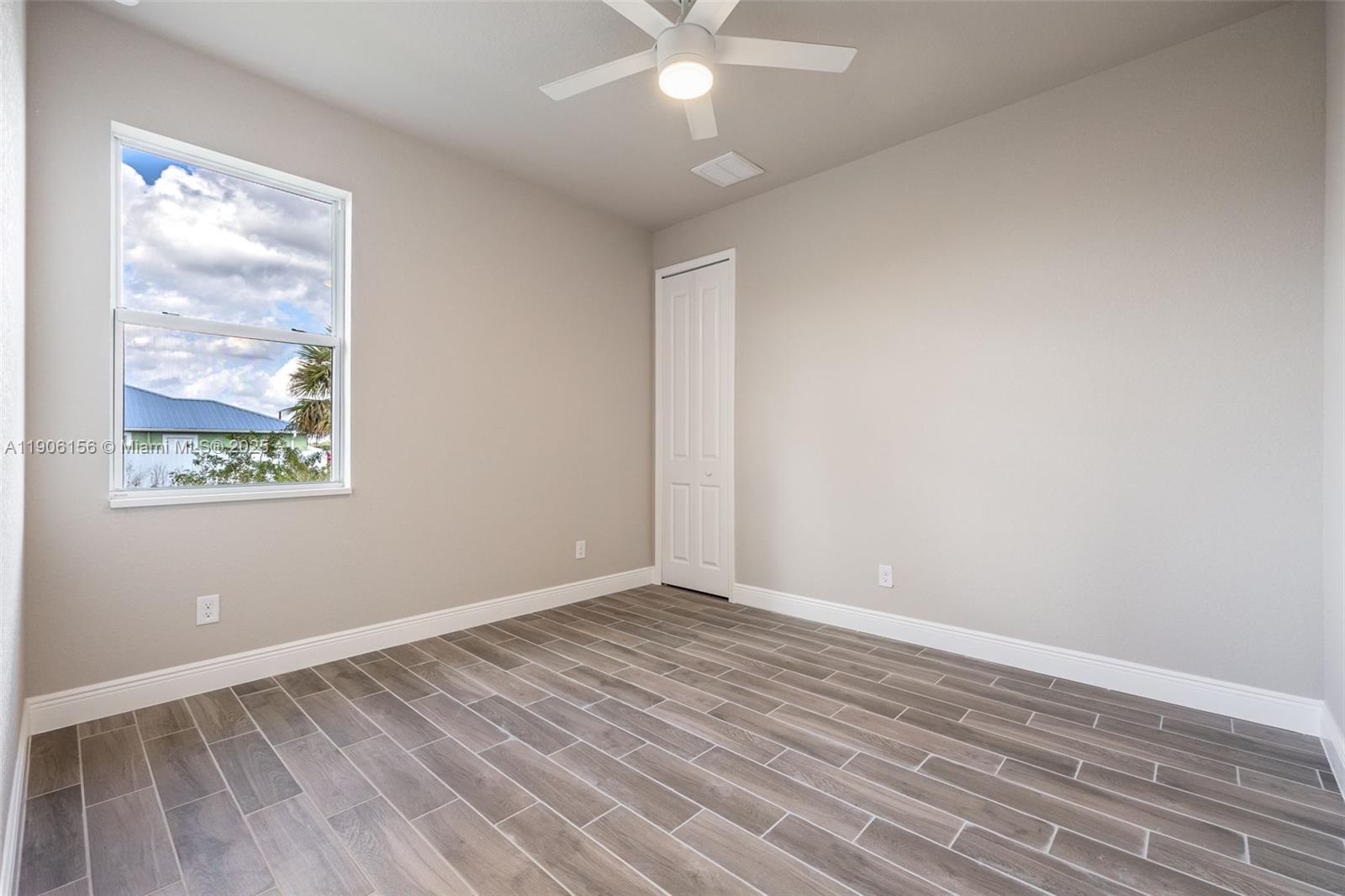 626 Royce Road LaBelle, FL 33935 - Photo 20 of 40 a view of an empty room with wooden floor and a window