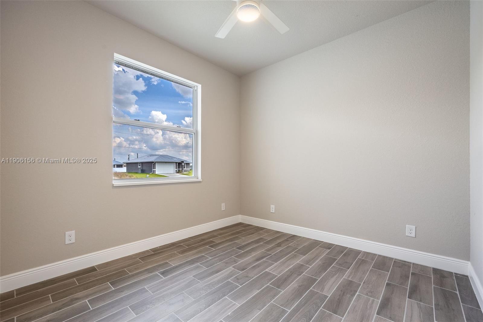 626 Royce Road LaBelle, FL 33935 - Photo 21 of 40 a view of an empty room with wooden floor and a window