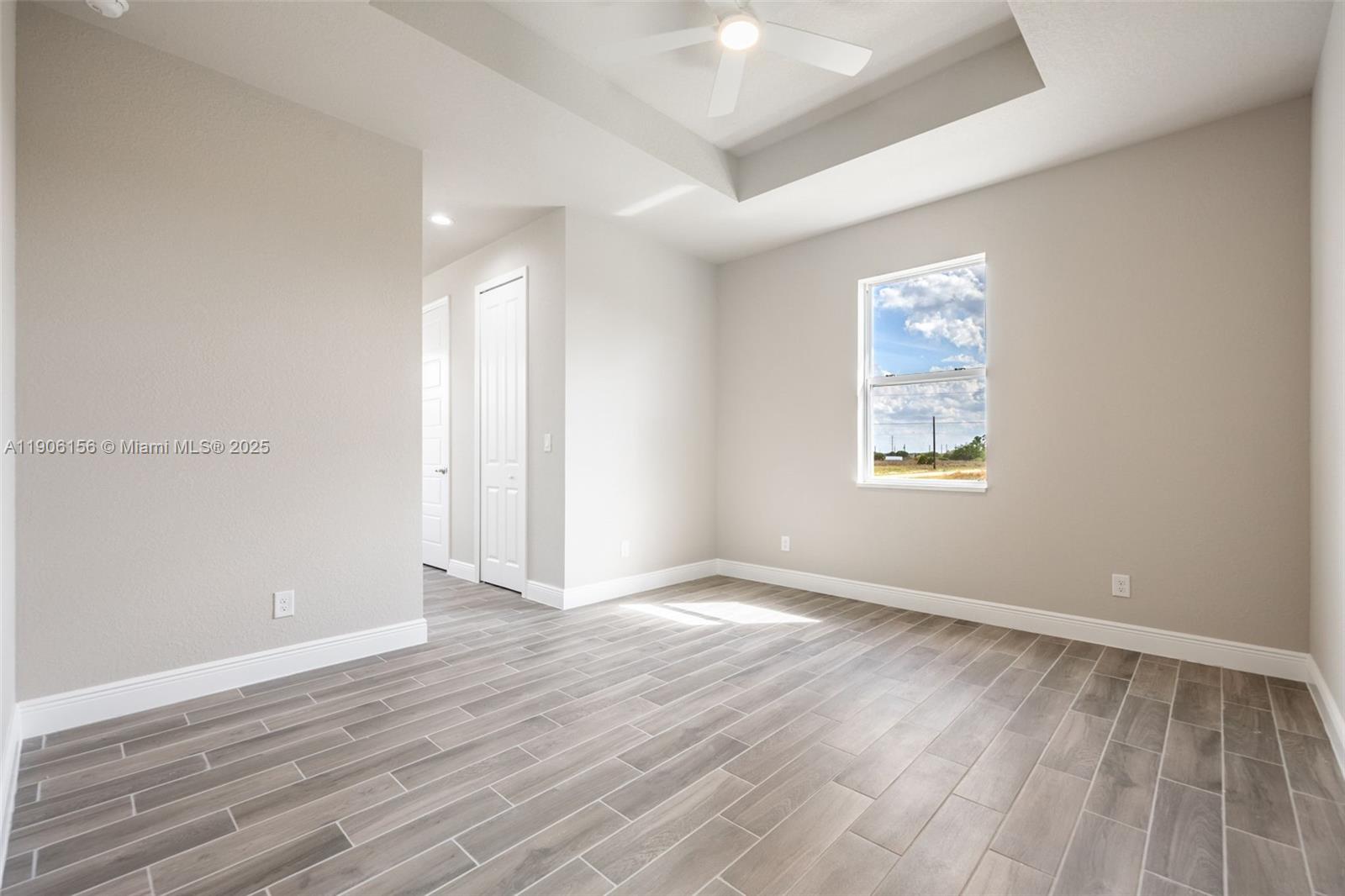 626 Royce Road LaBelle, FL 33935 - Photo 22 of 40 an empty room with wooden floor and windows
