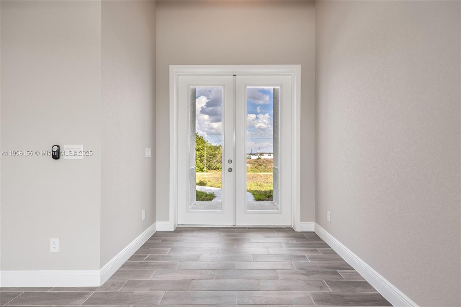 626 Royce Road LaBelle, FL 33935 - Photo 3 of 40 an empty room with window and wooden floor
